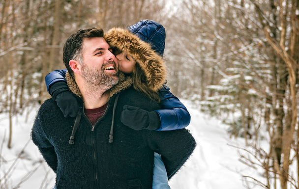 Handsome dad and his daughter are having fun outdoor in winter - Foto, Bild