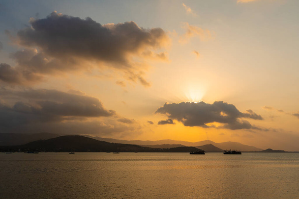Sunset over the bay with fishing boats. - 写真・画像