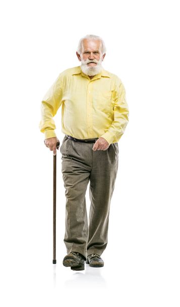 Bearded man walking with cane - 写真・画像