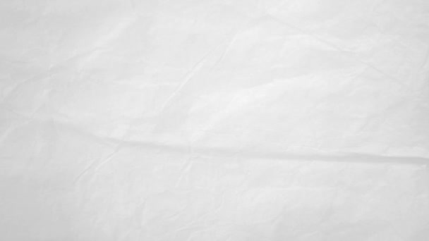Plain White Crumpled Paper Texture Animated Background Loop.Een looped stop motion animated achtergrond video van verschillende opnamen van effen wit verfrommeld papier met een lichte ruis grunge effect voor het componeren. - Video