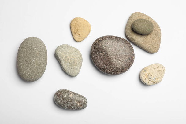 Many different stones on white background, top view - Photo, Image