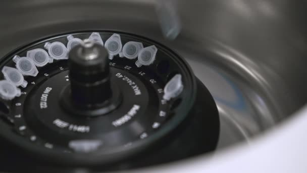 Laboratoriummedewerker plaatst chemische buizen in de centrifuge.  - Video