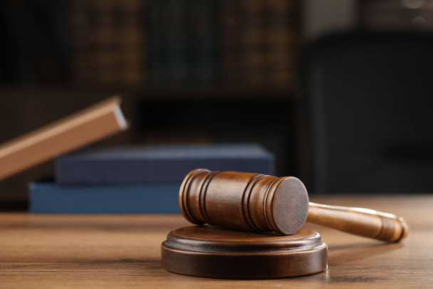 Wooden gavel on table against blurred background - Photo, image