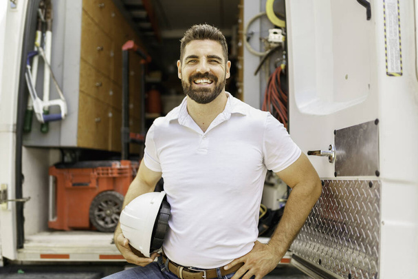 man with a hard hat standing in front of truck - Photo, Image