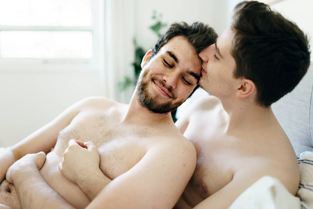 homosexual couple under a bed at home - Valokuva, kuva