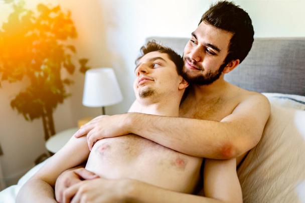 homosexual couple under a bed at home - Фото, изображение