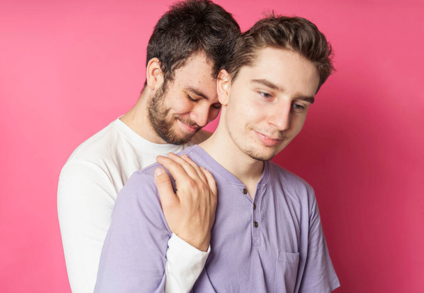 Young gay couple standing together over isolated ping background - Valokuva, kuva