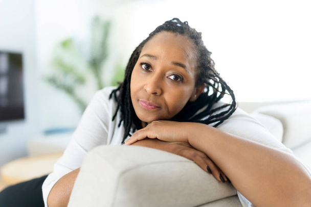 Portrait of an african woman sit on the sofa - Fotó, kép