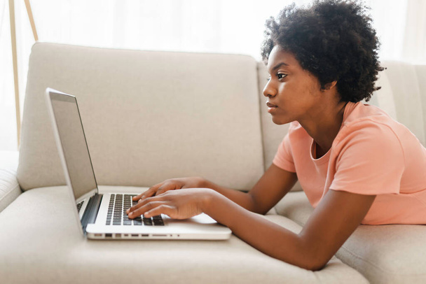 attractive young woman working with laptop on couch - Photo, Image