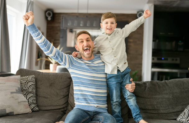 Father or Godfather having fun on the living room At Home hand high - 写真・画像