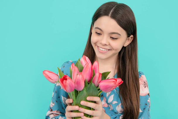 floral present. happy child hold tulips. mothers or womens day. kid hold flowers - Fotografie, Obrázek