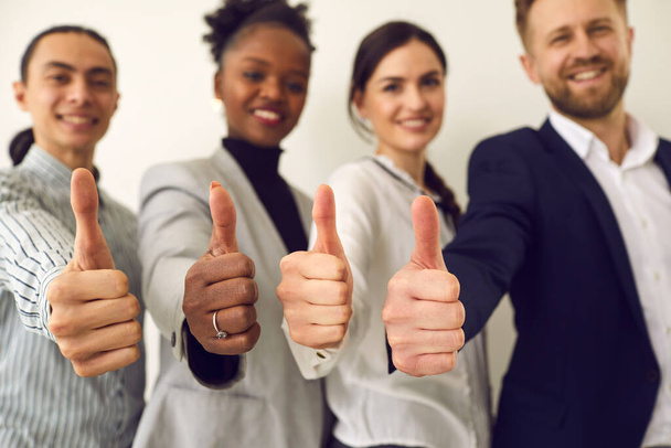 Thumbs up recommend gesture showing by diverse business team positive people - Foto, immagini