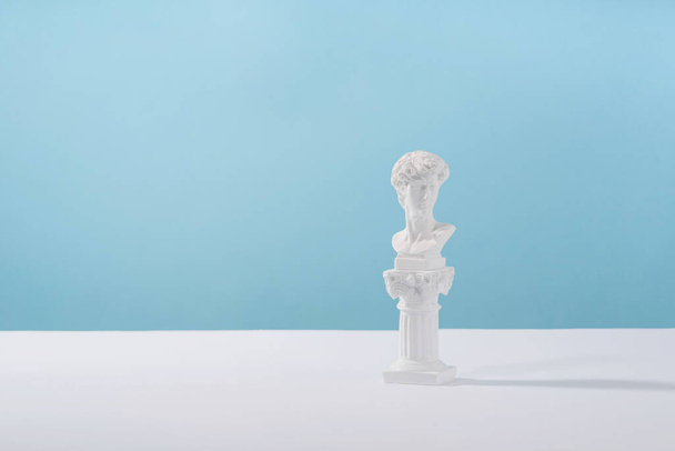 Cosmetic display podium platform greek man with roman marble column for product presentation, cosmetics geometric stand stylish props, mockup scene aesthetic on blue. Creative product stage.. - Фото, зображення