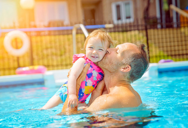 father with the child girl in the pool - Photo, Image