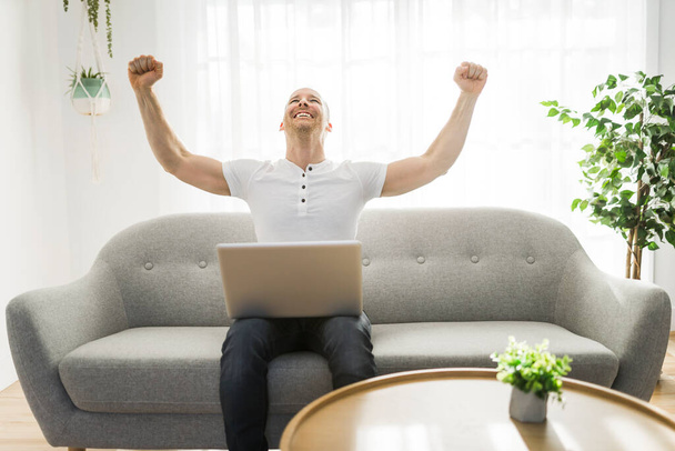 man happy and success working on computer laptop at home - Valokuva, kuva