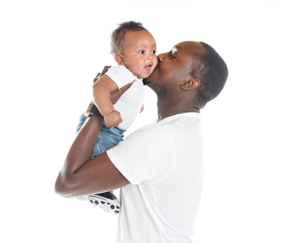 portrait of beautiful african man holding on hands her little son on white background - Foto, imagen
