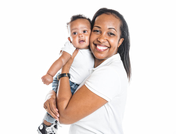 portrait of beautiful african woman holding on hands her little son on white background - Photo, image