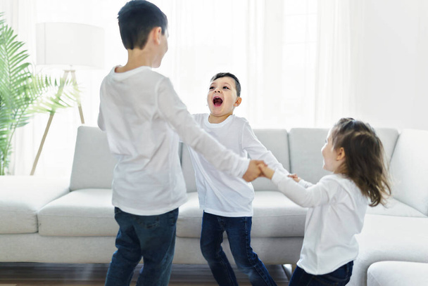childs having fun on living room at home - 写真・画像