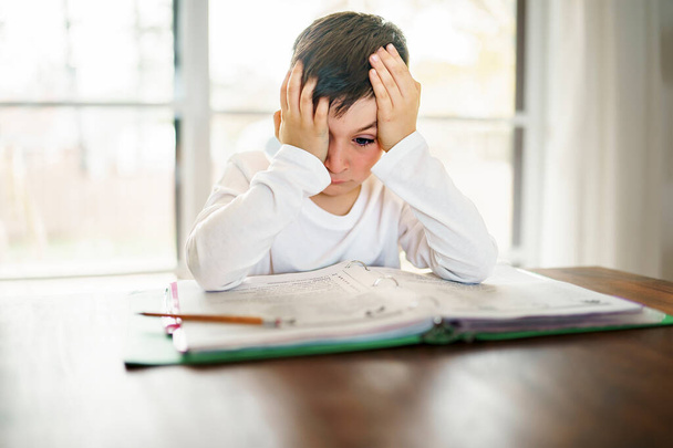 Pensant enfant ennuyé et frustré et fatigué de faire ses devoirs - Photo, image