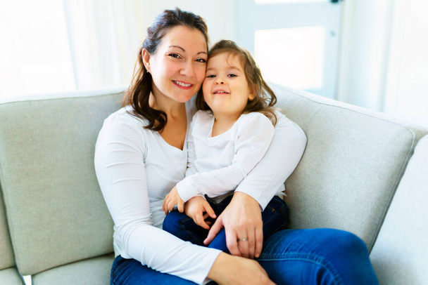 Mother with her daughter having fun in living room at home - Photo, Image
