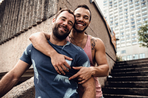 A Portrait of a happy gay couple outdoors in urban background - Foto, Bild