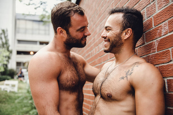 A Portrait of a happy gay couple outdoors in urban background - Foto, Bild
