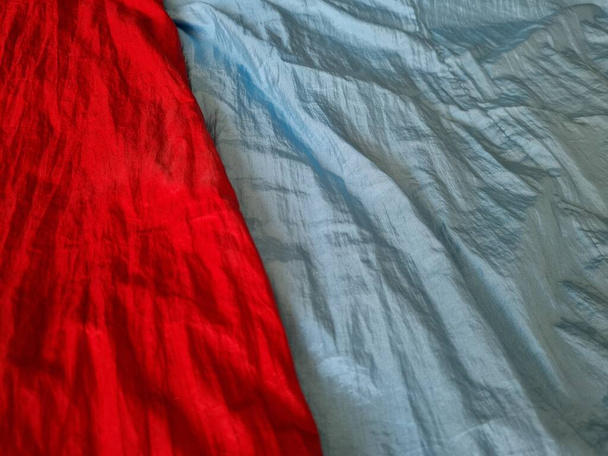 Abstract textured background of mukena cloth for prayer in red and light blue colors - Foto, Imagen