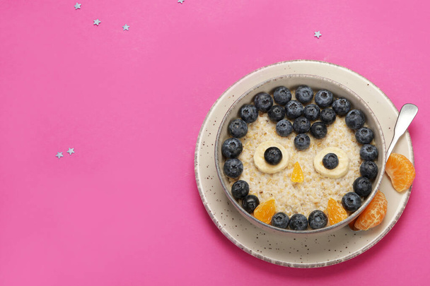 Oatmeal for kids on coloutfull background. Healthy breakfast idea. Playful lunch. Top view, flat lay, copy space - Foto, afbeelding