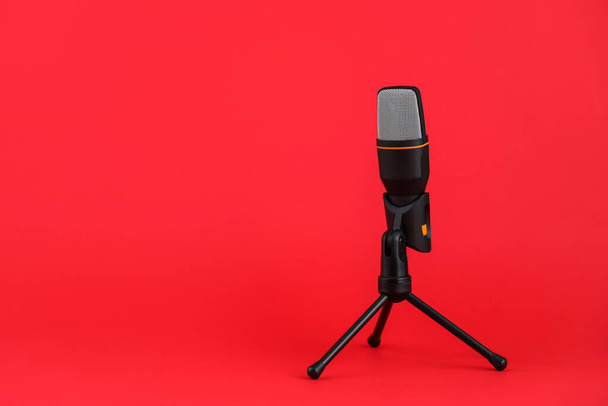 Stand with microphone on red background - Foto, afbeelding