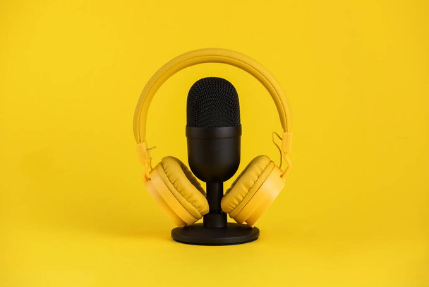 Microphone and headphones on yellow background - Foto, imagen