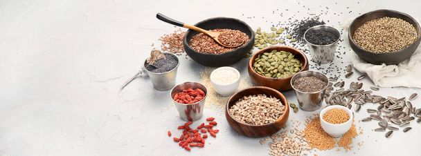 Variety of edible seeds on light background. Cereal and grains. Healthy food concept. copy space, panorama - Photo, image
