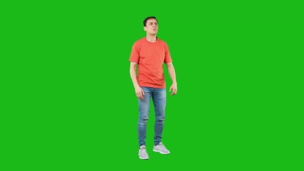 Worried male looking at distance. Green background - Video, Çekim