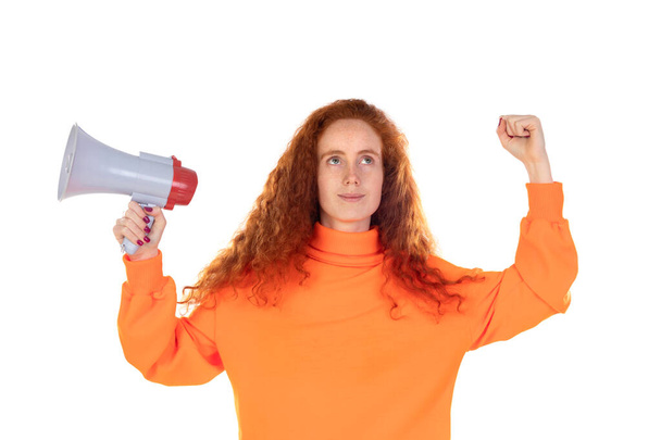 Young redhead woman girl in orange weater posing isolated on white wall background. People lifestyle concept. Scream in megaphone - Photo, Image