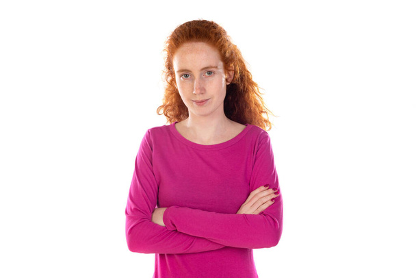 Redhaired young woman wearing a pink t-shirt isolated on a white background - Zdjęcie, obraz