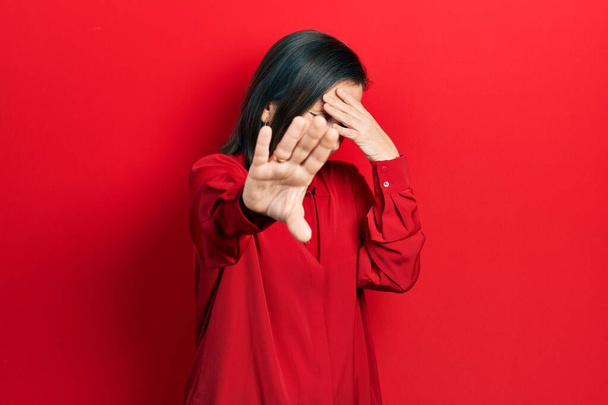Middle age hispanic woman wearing casual clothes covering eyes with hands and doing stop gesture with sad and fear expression. embarrassed and negative concept.  - Foto, immagini