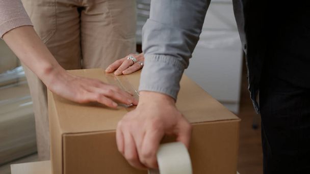 Couple packing up storage things in cardboard boxes - Photo, Image
