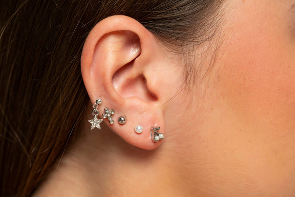 ear piercings photos.Helix piercing.Ear rings. Close up. - Photo, Image