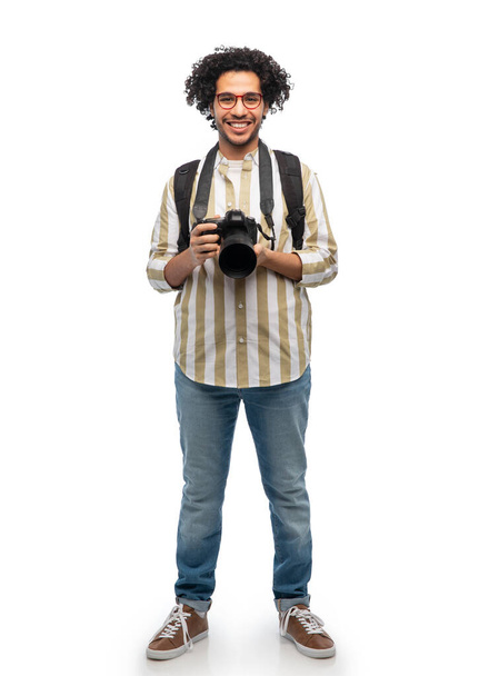 smiling man or photographer with digital camera - Foto, Bild
