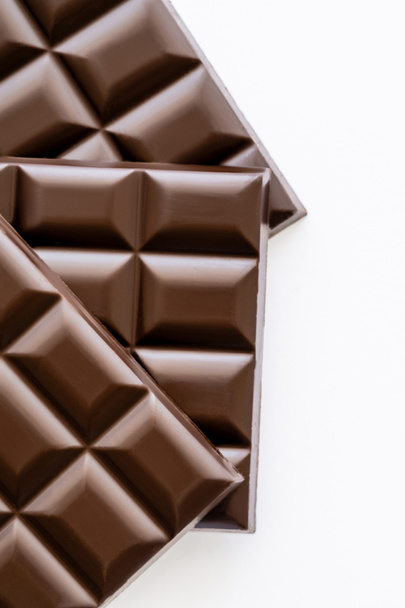 Top view of brown chocolate bars isolated on white  - Φωτογραφία, εικόνα