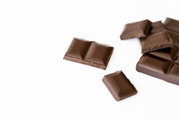 Close up view of blurred chocolate pieces isolated on white  - Valokuva, kuva