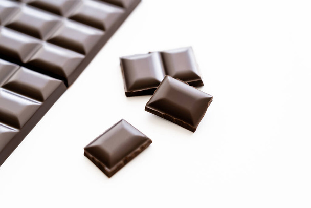 Close up view of dark chocolate on white background  - Foto, afbeelding