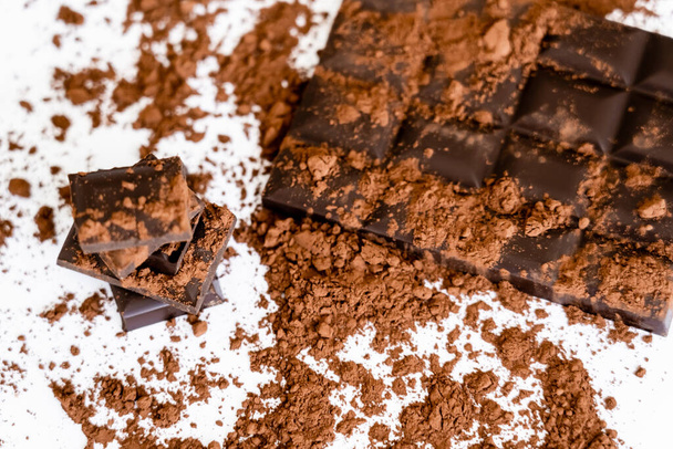 Top view of natural cocoa and chocolate on white background  - Valokuva, kuva