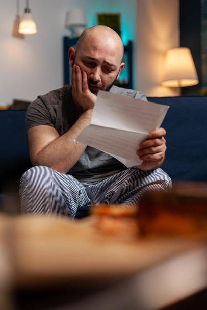 Sad disappointed man feeling worried about eviction notice warning - Photo, Image
