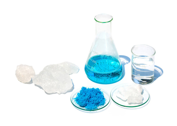 Closeup inorganic chemical on white laboratory table. Copper(II) sulfate, Alum Crystal and alcohol. Chemical ingredient for Cosmetics and Toiletries product. - Photo, Image