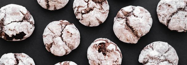 Top view of tasty biscuits with powdered sugar on black background, banner  - Foto, Imagen