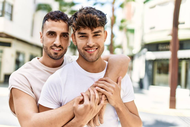 Two hispanic men couple smiling confident hugging each other standing at street - Fotografie, Obrázek