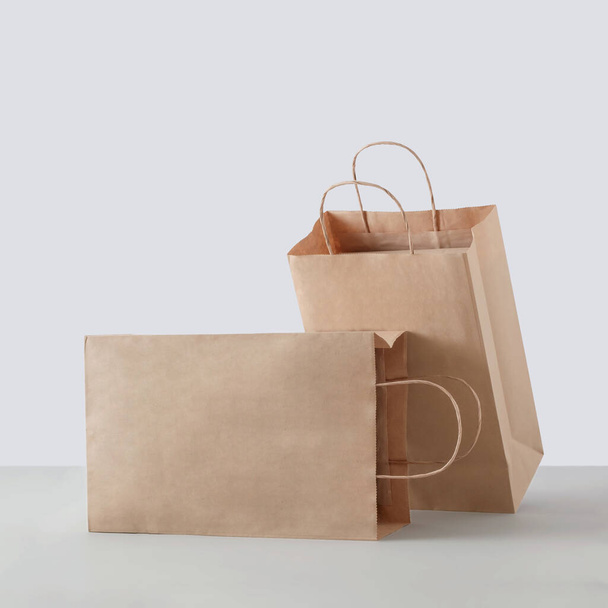 Two paper carton bags for commercial shopping in the store. Mockup for business or delivery. - Fotó, kép