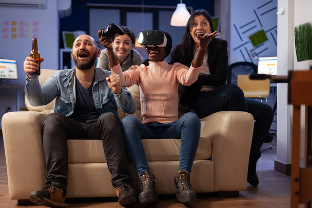 Diverse group of workmates playing video games with vr headset - Foto, imagen