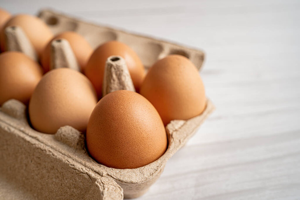 Organic fresh eggs in cardboard container pack with copy space, organic healthy food. - Photo, image