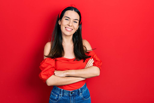 Young brunette woman wearing casual red shirt happy face smiling with crossed arms looking at the camera. positive person.  - Photo, Image